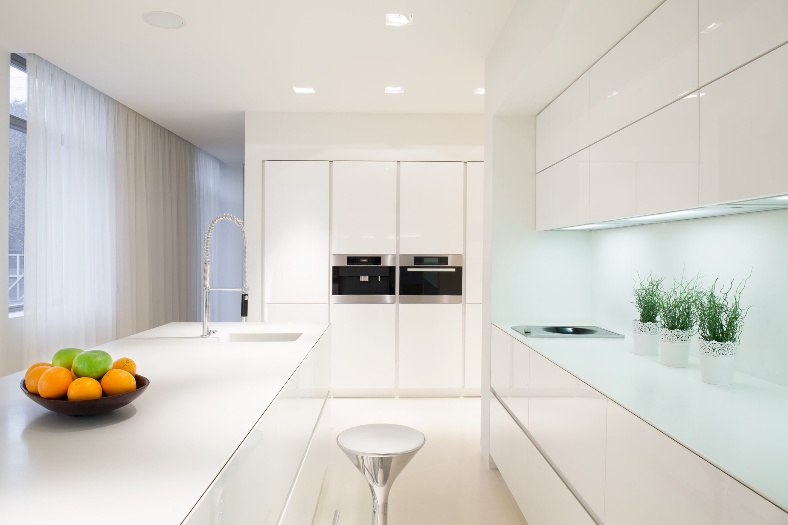 Horizontal view of exclusive white kitchen interior